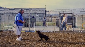 Michael Duran works with a dog in the Paws on a Mission program in the training area at Solano State Prison.