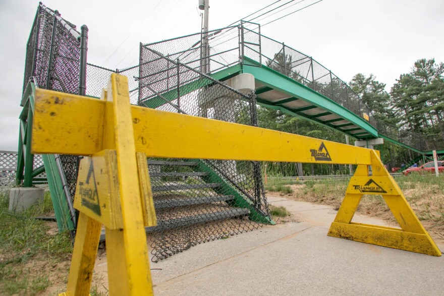 The pedestrian bridge over U.S. 31 at the Traverse City State Park was struck by an excavator towed by a truck on Thursday in Traverse City.