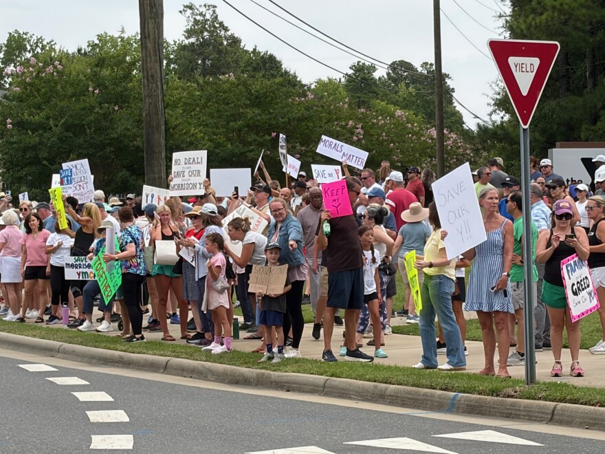 Protestors line the street outside the Morrison Family YMCA. 