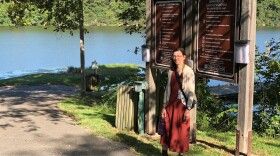 Alison Jumper, Director of Fayetteville Parks, Natural Resources & Cultural Affairs, stands near outdoor permit fees payment drop box.