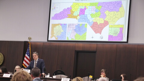 FILE - The North Carolina Senate reviews copies of a map proposal for the state's congressional districts starting in 2024 during a committee hearing at the Legislative Office Building, Oct. 19, 2023, in Raleigh, N.C.
