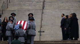The Rev. Jesse Jackson's casket is taken up the Statehouse steps with family members watching.