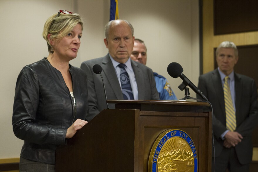 Alaska Attorney General Jahna Lindemuth speaks to reporters at a press availability on Sep. 15. Gov. Bill Walker and Corrections Commissioner Dean Williams are also pictured. (Photo by Daniel Hernandez, Alaska Public Media – Anchorage)