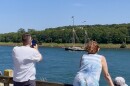 Spectators watch from along the Cape Cod Canal as the 130-foot tall ship Angelique makes it way through the canal on its way to Boston for Sail250, July 9, 2026.