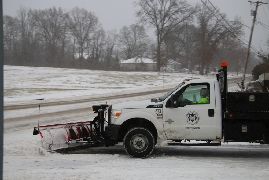 A City of Columbia snowplow clears a road during a snowstorm.