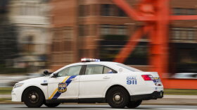 A police car drives with its lights flashing in Philadelphia, Tuesday, Jan. 8, 2019. (AP Photo/Matt Rourke)