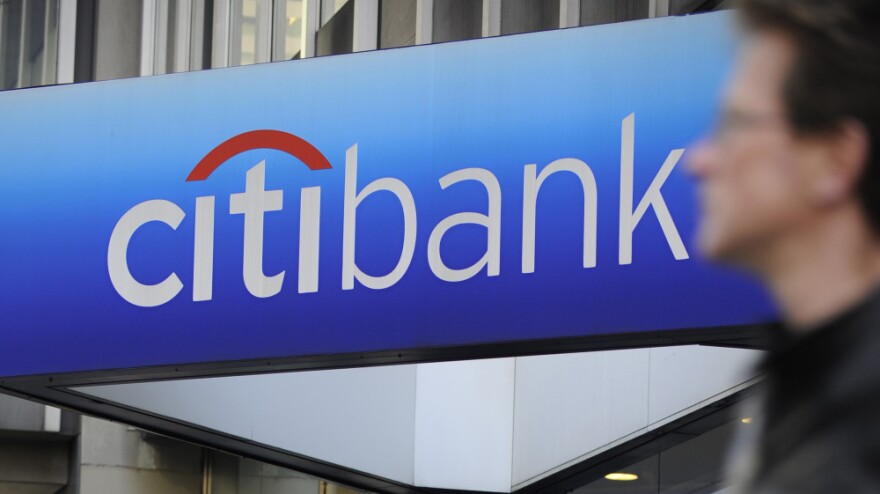 A man walks by a Citibank branch at the U.S. bank Citigroup world headquarters on Park Avenue, in New York in 2008.