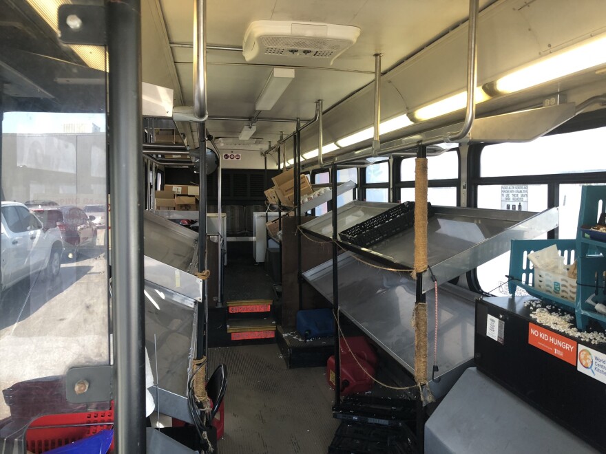 Shelving and coolers sit mostly empty in the Fresh2You Mobile Market; the bus hasn't gone on its regular food delivery rounds to public housing complexes since the rise of the COVID-19 pandemic.