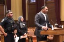 Carle Health's Trillium Place community services executive director Dr. Derrick Booth speaks to the Peoria City Council as Peoria Police Chief Eric Echevarria and co-response program director Shamim Jaleel listen Tuesday at City Hall.