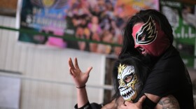 Angel De Paz (top) grapples with El Diablo (bottom) in the ring as they practice for their upcoming luchador performances.