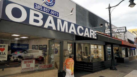 FILE: An Obamacare sign is displayed outside an insurance agency on November 12, 2025 in Miami, Florida. House Democrats are said to be looking at steps to force a vote on extending the expiring Affordable Care Act tax credits after Republicans did not address the issue as part of a deal to reopen the federal government.