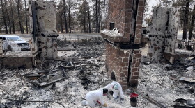 Archaeologists from the Alta Heritage Foundation sift through the rubble of CaitLynn and Keenan Burt's Spokane home.
