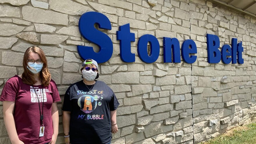 Sage Wright, left, and Mikaela Coppedge, right, stand outside Stone Belt, a nonprofit that supports people with intellectual and developmental disabilities. Coppedge lives and Wright works at Blackstone House, one of Stone Belt's group homes.