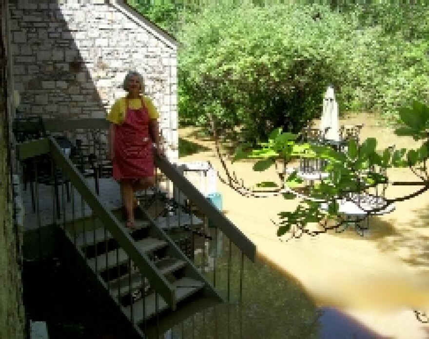Pat Greer of Frankfort inspects her flooded patio.