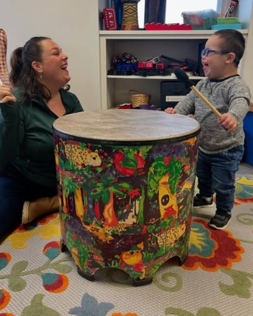 Music Therapist working with a happy child.