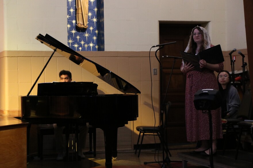 Codi Linafelter (middle), 21, alongside her peers, prepares for mass to begin on Sunday. (Nicole Beltran/WUFT News)