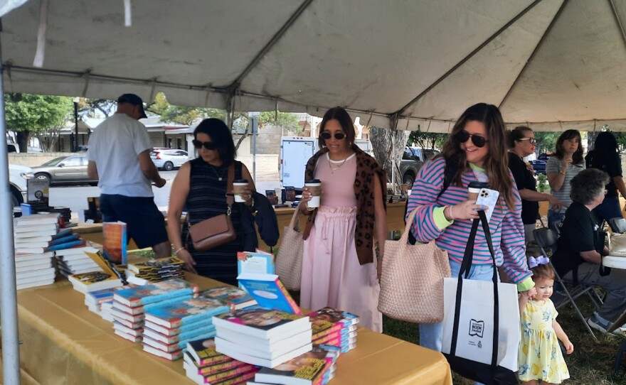 Readers ogle the books.