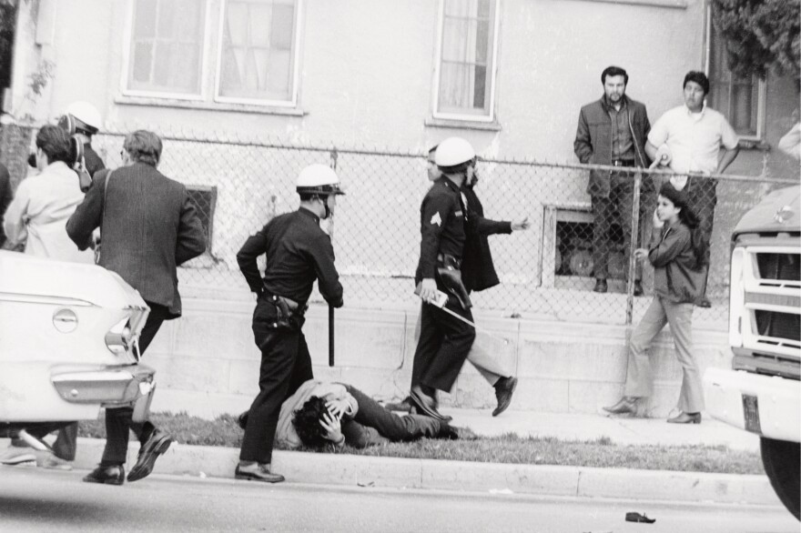 In 1968, Chicano students staged walkouts to protest unequal conditions in Los Angeles public schools. Prior to this shot, a student was hit in the head by police officers.