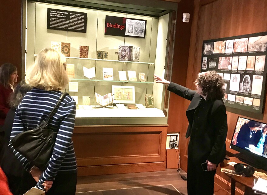 Lisa Unger Baskin shows visitors to an exhibit at the Grolier Club examples of books made by women through the centuries.