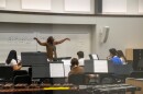 A teacher conducts students in an orchestra class inside one of the new soundproofed studios in the Fine Arts Center at Canterbury School.