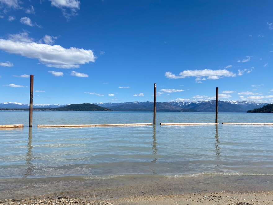 The shores of Lake Pend Oreille in Sandpoint, Idaho on a sunny day with blue skies.