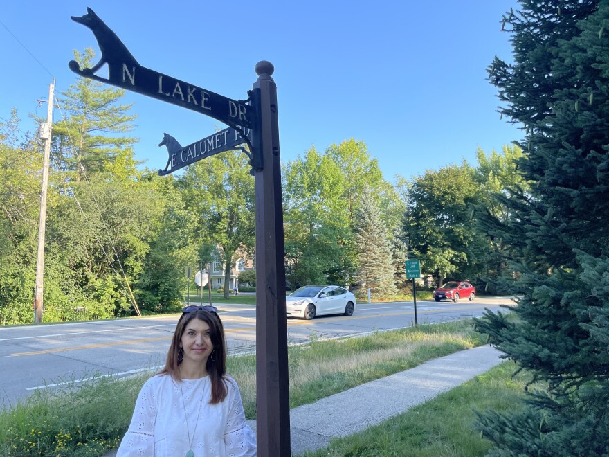 Bubbler Talk question asker stands under the nearly 100-year-old street signs in the village of Fox Point.