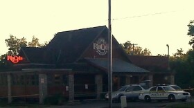 Yellow crime scene tape surrounds the 16th and Harvard Rib Crib at daybreak on Friday.