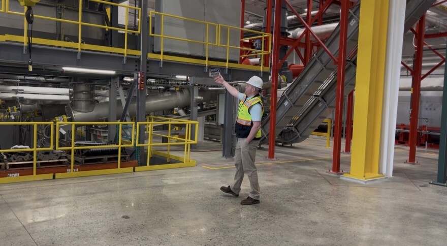Matt Ursillo of Quonset Soil Solutions, a subidiary of Cranston-based Green Solutions LLC, leads a tour of the company's new wood chip pyrolysis plant in Quonset Business Park. The company wants to build an additional plant nearby burning sewage sludge.