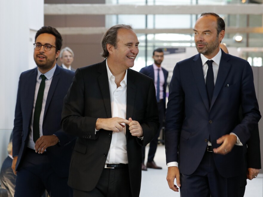 Xavier Niel, center, speaks with French Prime Minister Edouard Philippe and Minister for the Digital Sector Mounir Mahjoubi, left, as they visit the startup incubator Station F in Paris on Aug. 31.