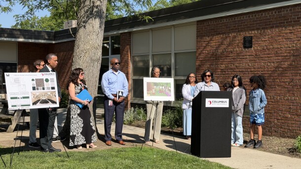Columbus City Schools Superintendent Angela Chapman speaks at press conference at Salem Elementary School, with mock-ups of school renovation projects.