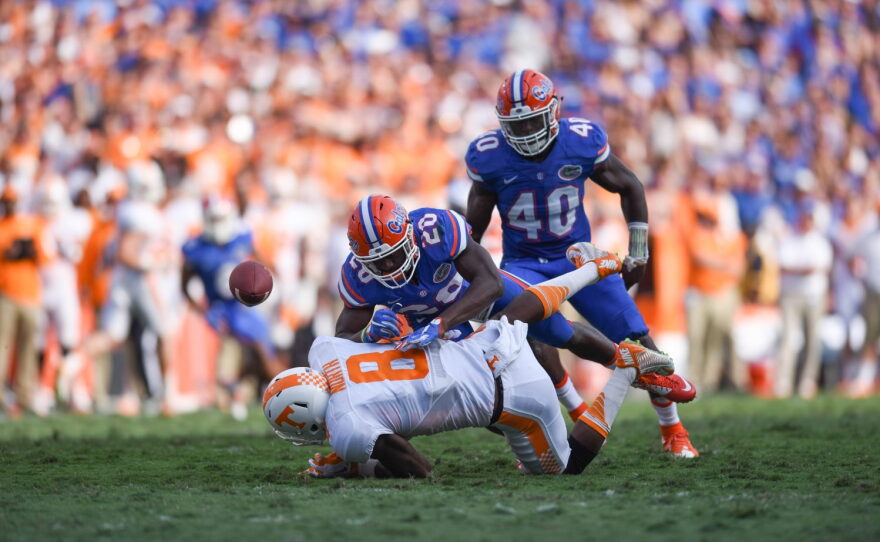 After making a reception, Tennessee wide receiver Marquez North (8) gets hit hard by Florida defensive back Marcus Maye (20).
