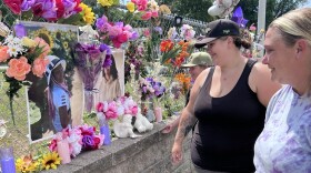 Chantel Smith, right, smiles at a photo of her daughter Lexi Thornton. Former neighbors Simone Aune and her son Landon Gorton were reminiscing July 17, 2026, outside Smith's Brainerd home. A memorial continues to grow in honor of 13-year-old Lexi, who died by suicide on July 10.