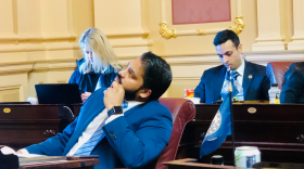 Northern Virginia Senator Saddam Salim peers at the vote board during a Senate floor session.