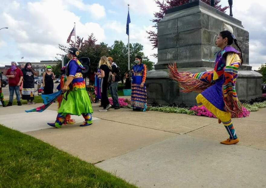 Native American protesters of the George Armstrong Custer monument dance in front of the monument