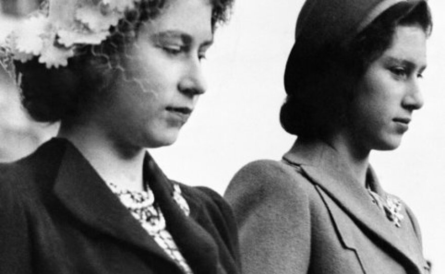 In this 1945 picture, Princess Elizabeth (left) wears a left halo hat trimmed with flower designs as she stands next to her sister, Princess Margaret Rose, during the wedding of Diana Piers Legh and the Earl of Kimberley at Windsor Castle in London. 