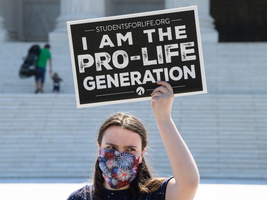 An anti-abortion-rights activist demonstrates in front of the U.S. Supreme Court in June. Many Trump voters (or potential Trump voters) bring up abortion in explaining their voting rationale.