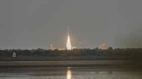 A rocket launches into the sky. 