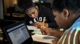 Curiah Simpson, 18, and Destiny Taylor, 12, work on their school work at the dining room table in their home in North College Hill on Thursday, April 2, 2020. The sisters expressed how much they missed being in a classroom and having teachers to help them