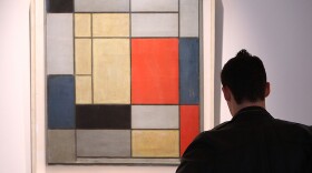 A man looks at <em>Composition I</em> by Piet Mondrian on January 29, 2009, at Christie's in London.