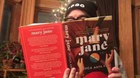 Lisa Morgan enjoys Jessica Anya Blau's book 'Mary Jane' in front of her Christmas tree in Baltimore. credit: T. Goldsmith