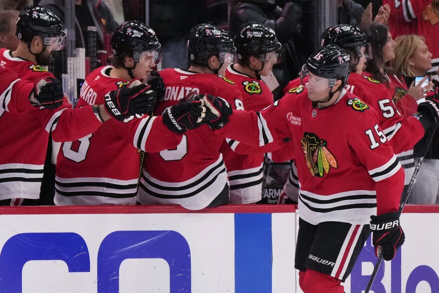 Chicago Blackhawks center Craig Smith (15) celebrates with teammates after scoring during the second period of an NHL hockey game against the Columbus Blue Jackets in Chicago, Sunday, Dec.1, 2024. (AP Photo/Nam Y. Huh)