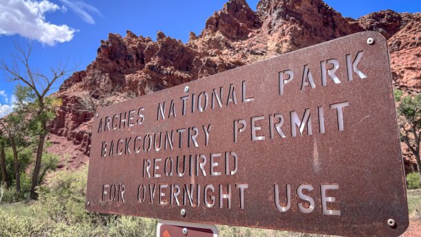 A sign at the boundary of Arches National Park in southeast Utah, Aug. 19, 2024. After four years of requiring visitors to get a timed-entry permit, the park will now allow people to enter without a reservation.
