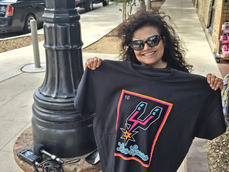The Spurs may be one game away from elimination, but they did not stop Deborah Garcia from buying this loteria style t-shirt at Market Square on June 11, 2026