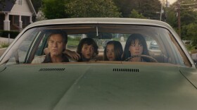 Anne Hathaway sits in a car alongside Ewan McGregor and child actors Maisy Stella and Christian Convery in the movie The End of Oak Street.