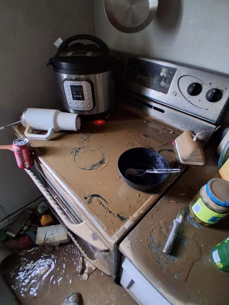 A stove is covered in mud inside Alissa Gerber's home in Connersville. Her home was destroyed by last week's flooding.