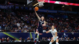 Paige Bueckers #5 of the UConn Huskies break away layup in front of Hannah Jump #33 of the Stanford Cardinal in the fourth quarter during the 2022 NCAA Women's Final Four semifinal game 2 at Target Center on April 01, 2022 in Minneapolis, Minnesota.