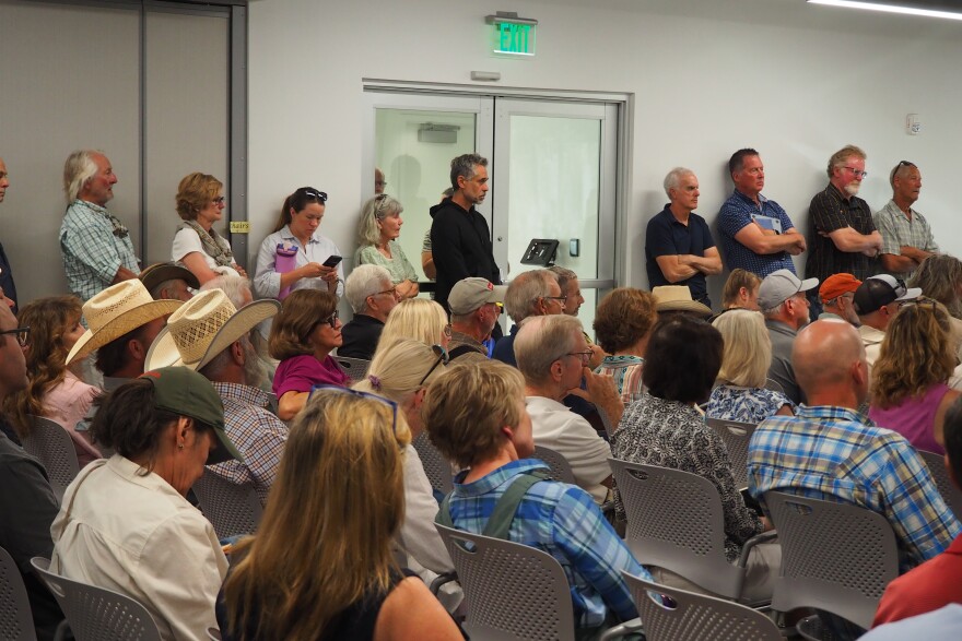 Summit County residents stand at an Aug. 6, 2026, Eastern Summit County Planning Commission hearing to see the slideshow presentation regarding Ivory Homes' potential development in Browns Canyon.