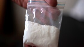 A cocaine consumer shows a bag of the drug. (Juan Manuel Barrero/AFP/Getty Images)