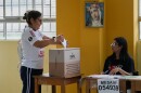 A woman votes as polling resumes at a station affected by delays and logistical problems during general elections in Lima, Peru, Monday, April 13, 2026.