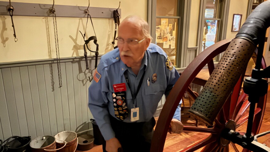 Retired Grand Rapids firefighter Dave Tiesma talks to visitors at the Grand Rapids Public Museum.